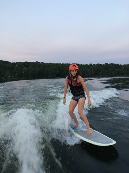 Summer camp counsellor wakesurfing